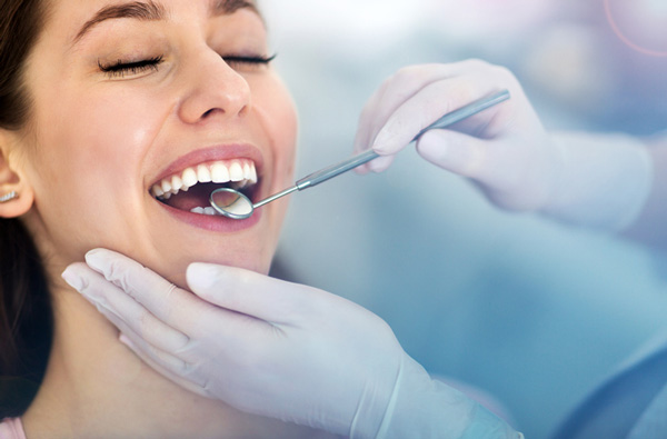 Woman getting dental exam at Lakewood Dental Arts in Lakewood, CA