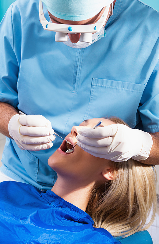 Dental professional focused on fixing a patient's mouth.